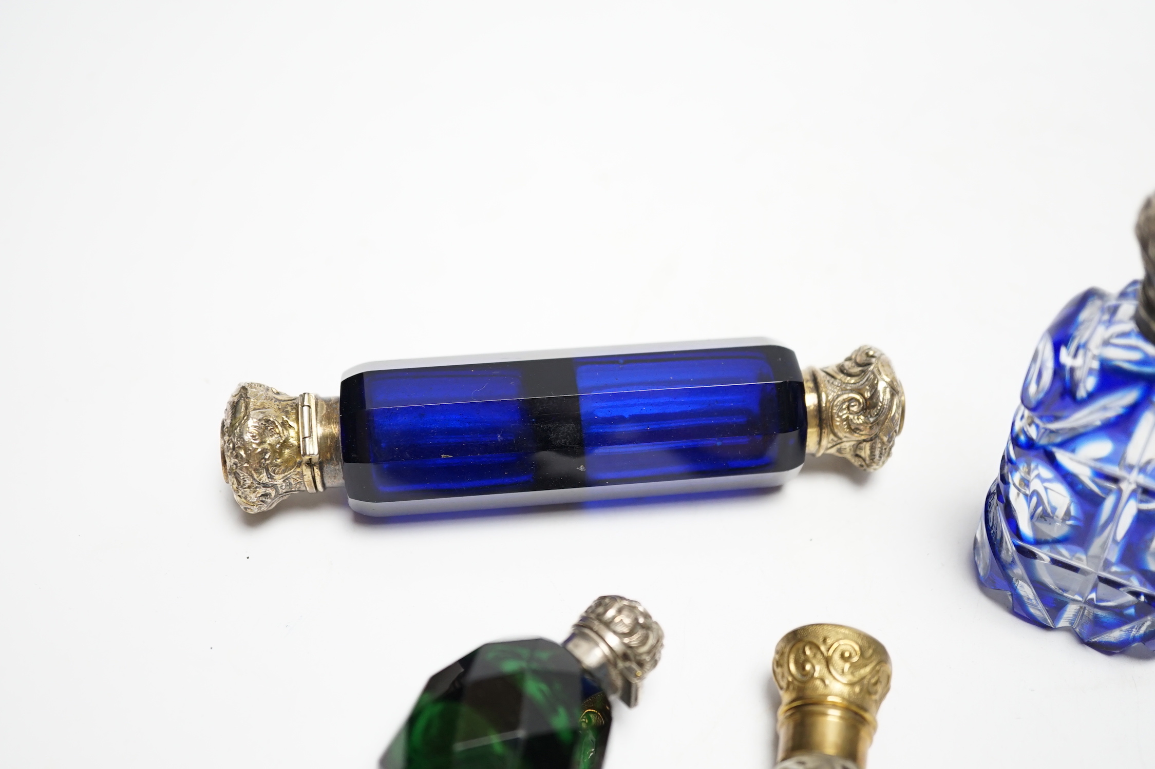 Four assorted Victorian white or gilt metal mounted cut glass scent bottles, including double ended blue glass scent bottle, 12.2cm.